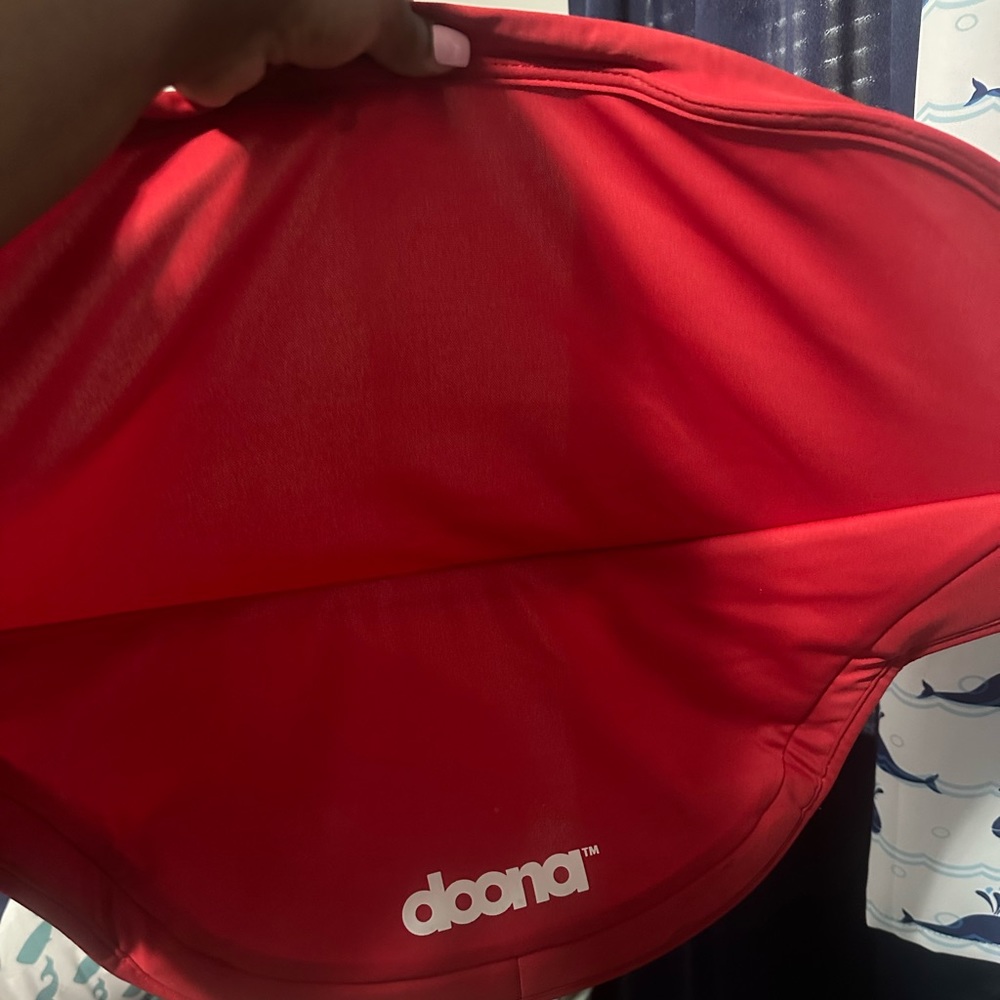 Red doona stroller cover with matching shoulder pads